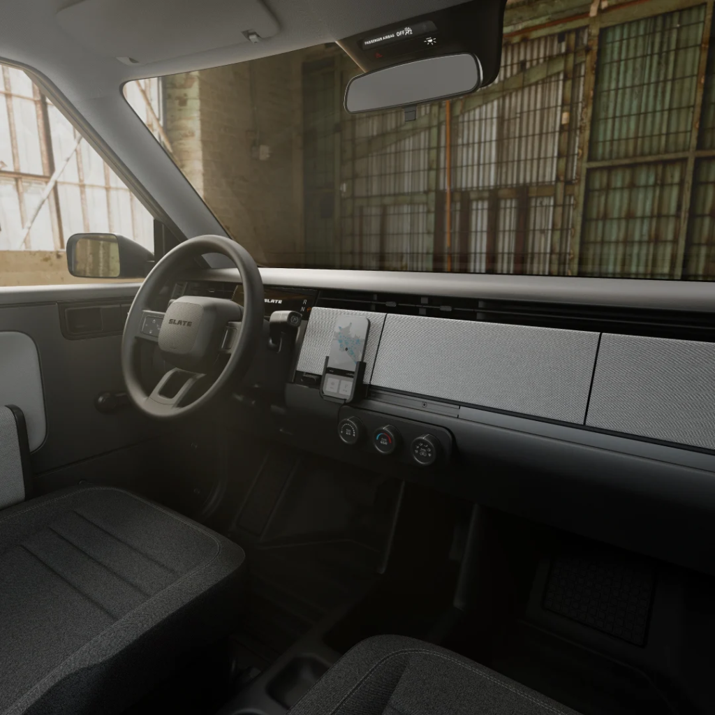 Minimalist interior of Slate Electric Truck with phone mount dashboard and optional AC, designed for low-cost EV driving
