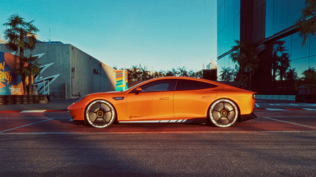 Side view of the Mercedes-AMG GT XX Concept displayed on a motor show platform, finished in Sunset Beam Orange with active aero wheels.