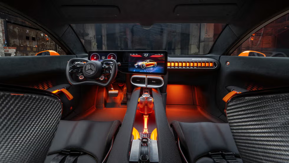 Driver-focused interior of the GT XX Concept featuring a minimalist dashboard, AMG yoke steering wheel, and carbon fiber racing seats.